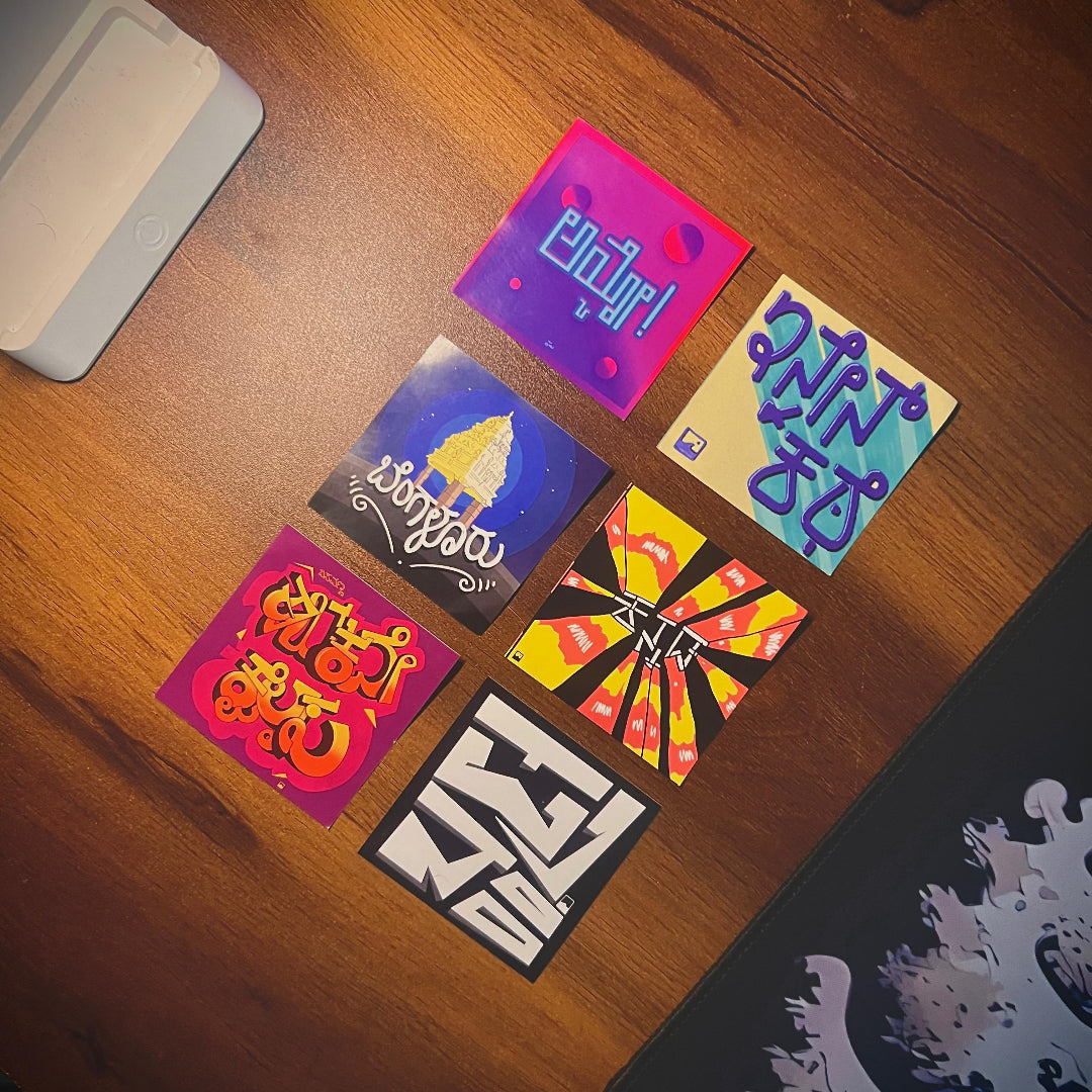 Colorful stickers with various designs on a wooden surface